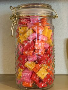 a glass jar filled with lots of colorful gummy bears