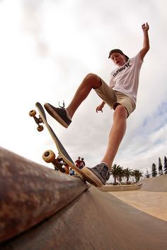 a man riding a skateboard up the side of a ramp