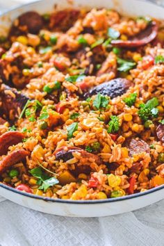 the recipe for chorizo rice in a skillet with text overlay that reads quick and easy one pot spanish dish