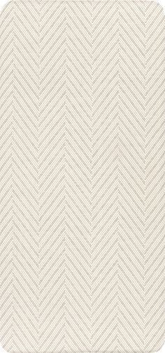 a white and beige chevroned wallpaper pattern