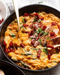 a skillet filled with pasta and meat