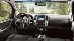 the interior of a vehicle with dashboard and steering wheel