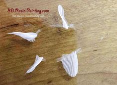 three white paper birds floating in the water