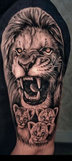 a man's arm with an image of a lion on it and three cubs