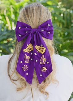 This fabric hair bow is such a fun Game Day accessory! The perfect way to cheer on your team! It features beaded megaphones, foam fingers, and pompoms. It is also accented with rhinestones as well. Fabric Hair Bow, Foam Finger, Fabric Hair Bows, Purple Gold, Hair Bow, Fun Games, Game Day, Hair Bows, Pom Pom