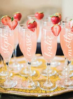 many wine glasses filled with different types of desserts