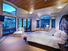 a bedroom with a large bed and fireplace in it