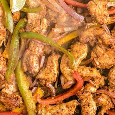 chicken and peppers are being cooked in a skillet