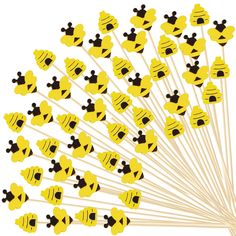 a bunch of yellow and black pins with mickey mouse faces on them in the shape of bees