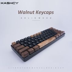 a computer keyboard made out of wood and black keys with walnut keycaps on it