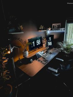 Work-from-home desk setup in a dark room illuminated by ambient lighting. Features dual monitors displaying large digital clocks, various plants enhancing the cozy atmosphere, a mechanical keyboard, and personal gadgets on a sleek wooden desk Home Office Inspiration Workspaces, Nature Setup, Office Inspiration Workspaces, Nice Houses, Computer Set, Planner Setup, Home Office Inspiration