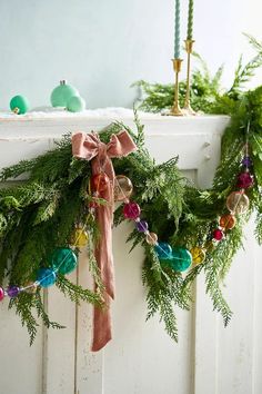 a christmas wreath with ornaments hanging from it