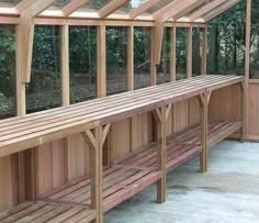 a wooden bench sitting inside of a greenhouse