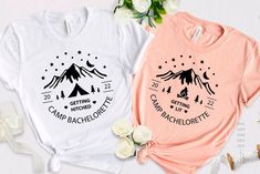 two t - shirts with camping designs on them sitting next to flowers and ribbon bows