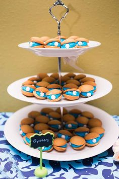 three tiered trays filled with cupcakes on top of a table