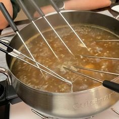 a pot filled with soup sitting on top of a stove