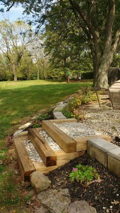 a wooden bench sitting in the middle of a park