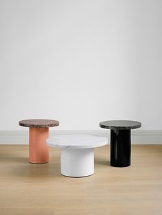 three different tables sitting on top of a hard wood floor next to a white wall