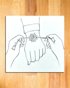 a drawing of two hands holding each other's hand on top of a piece of paper