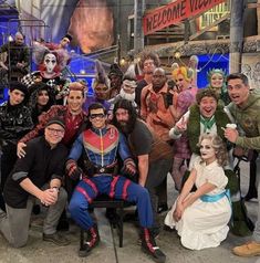 a group of people in costumes posing for a photo on the set of tv show