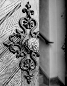 an ornate door handle on a wooden door