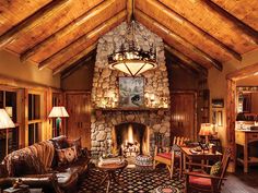 a living room filled with furniture and a fire place in the middle of a room