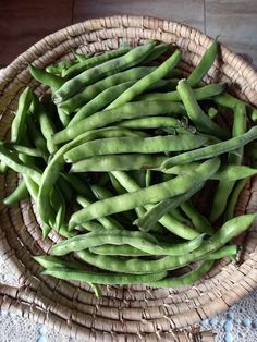 some green beans are in a wicker bowl