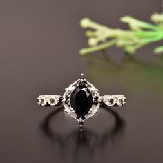 a black diamond ring sitting on top of a table