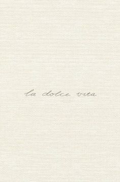 the words la dolce vita are written in cursive ink on white paper