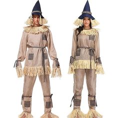 two women dressed in scare costumes standing side by side, one wearing a hat and the other wearing a costume with fringes