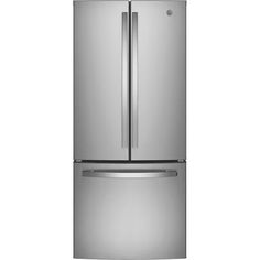 a silver refrigerator freezer sitting on top of a white wall