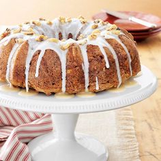 a bundt cake with white icing and sprinkles on a plate