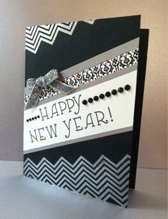 a new year's card with black and white designs on it, featuring a ribbon that says happy new year