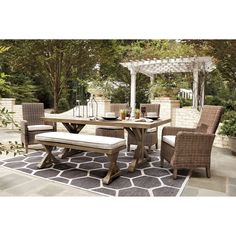 an outdoor dining table and chairs set up on a patio