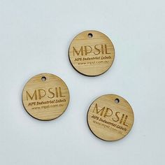 three wooden tags with the words mssl printed on them