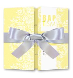 a yellow and white wedding card with silver ribbon