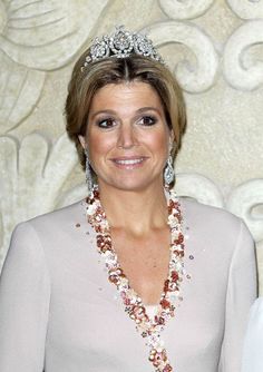 a woman wearing a tiara and smiling for the camera