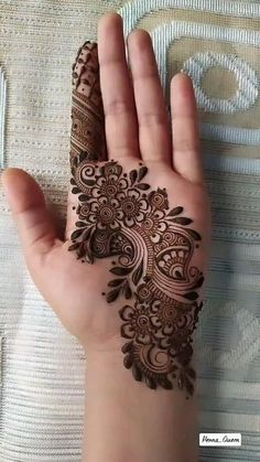 a person's hand with henna tattoos on it