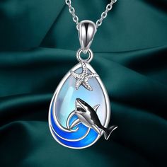 This Shark Necklace is a stunning piece that combines the power of the ocean waves with the allure of Moonstone. The shark symbolizes might and dominance in the sea, making it a great gift for marine animal lovers. The necklace is made of high-quality 925 sterling silver, including the pendant and chain. It is lead and nickel-free, providing a classic and natural look that is comfortable for long-term wear. The pendant measures 27.2mm (1.07 inches) by 13.8mm (0.54 inches), and it comes with an 18-inch chain plus a 2-inch extension. It is elegantly packaged in a gift box. Ocean-inspired Silver Gemstone Jewelry, Blue Round Pendant Jewelry, Celtic Knot Pendant, Shark Necklace, Mother Daughter Necklace, Silver Sea, Sterling Silver Heart Pendant, Music Jewelry, Ocean Jewelry