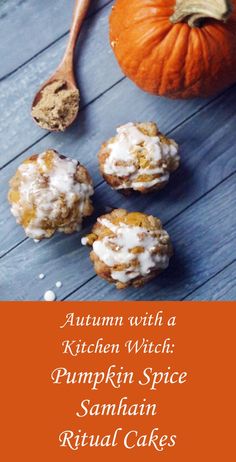 pumpkin spice cookies with white icing on a wooden table next to an orange pumpkin