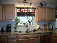 a kitchen with wooden cabinets and granite counter tops, along with a window over the sink