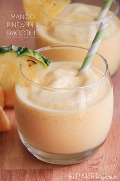 mango pineapple smoothie in small glasses with straws