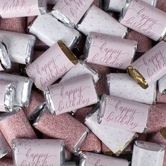 pink and silver candy bar wrappers with happy birthday written on the top in gold foil