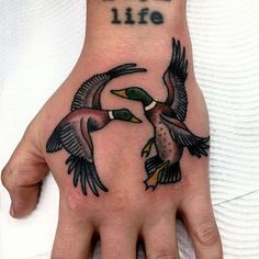 a person's hand with two birds on it and the words peace is life