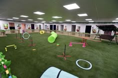 an indoor play area with artificial turf and toys