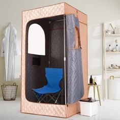 a room with a chair inside of it next to shelves and clothes on the wall