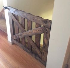 an open wooden gate in the corner of a room