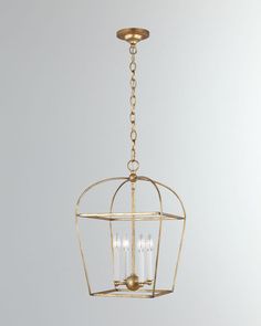 an antique brass cage chandelier hanging from a ceiling