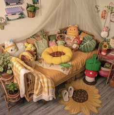 a bed with lots of stuffed animals on top of it next to plants and potted plants