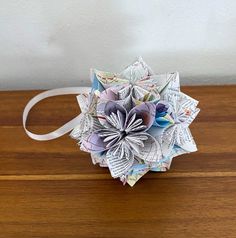 an origami flower on top of a wooden table